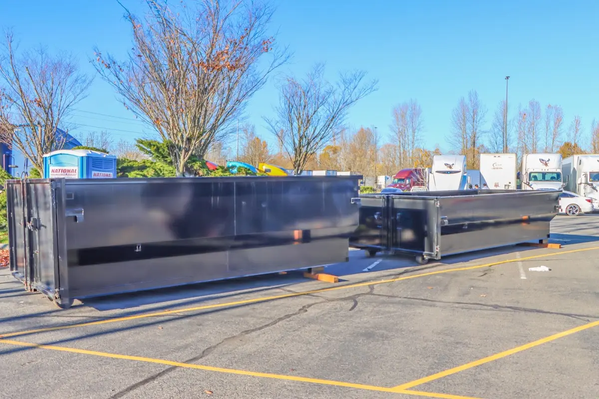 Professional dumpster rental service with roll-off container on residential driveway in Jonesborough